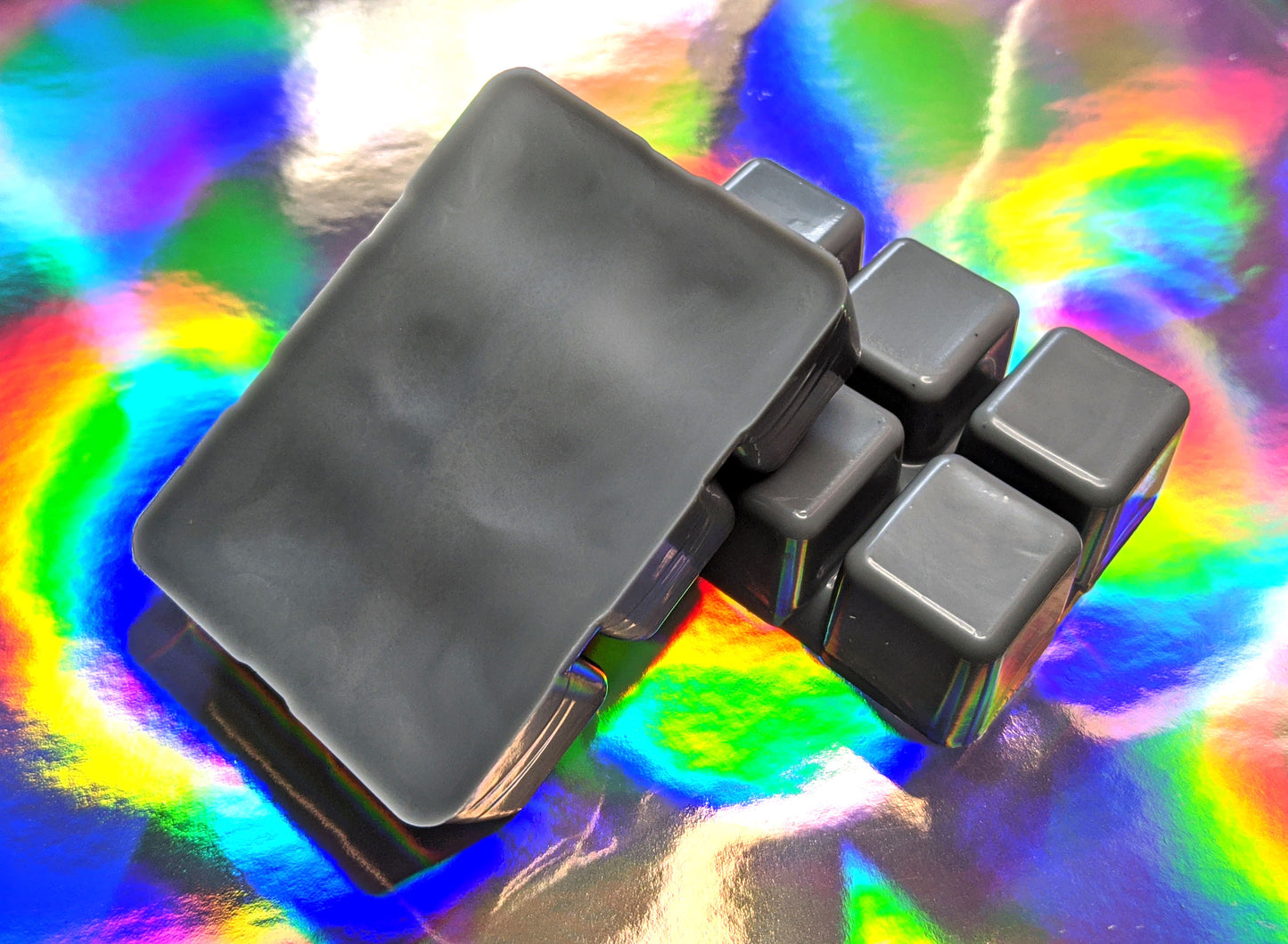 clamshell shaped wax that is colored black