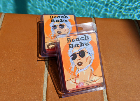 a wax melt label that pictures a girl with sunglasses. it reads "beach babe, wax melt, 3 ounces"