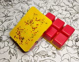 Clamshell shaped wax with a red base and yellow top. yellow and red chunky glitter on top.