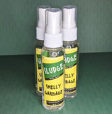 A spray bottle with a label that reads "Sludge, Body Spray, Smelly Garbage, cyclomethicone fragrance oil, Net wt. 2 ounces."