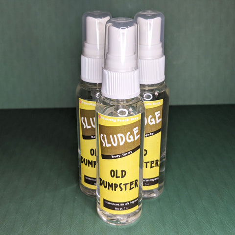 A spray bottle with a label that reads "Sludge, Body Spray, Old Dumpster, cyclomethicone fragrance oil, net wt. 2 ounces."
