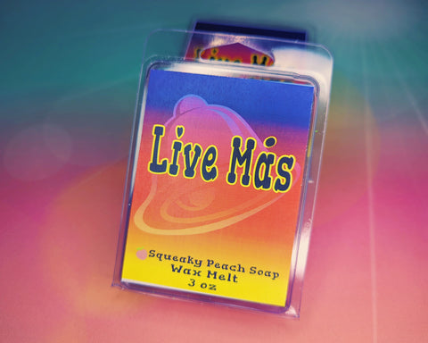 Rainbow colored label with an image of a bell. The packagaing reads "Live Mas, Squeaky Peach Soap, Wax Melt, 3 ounces."